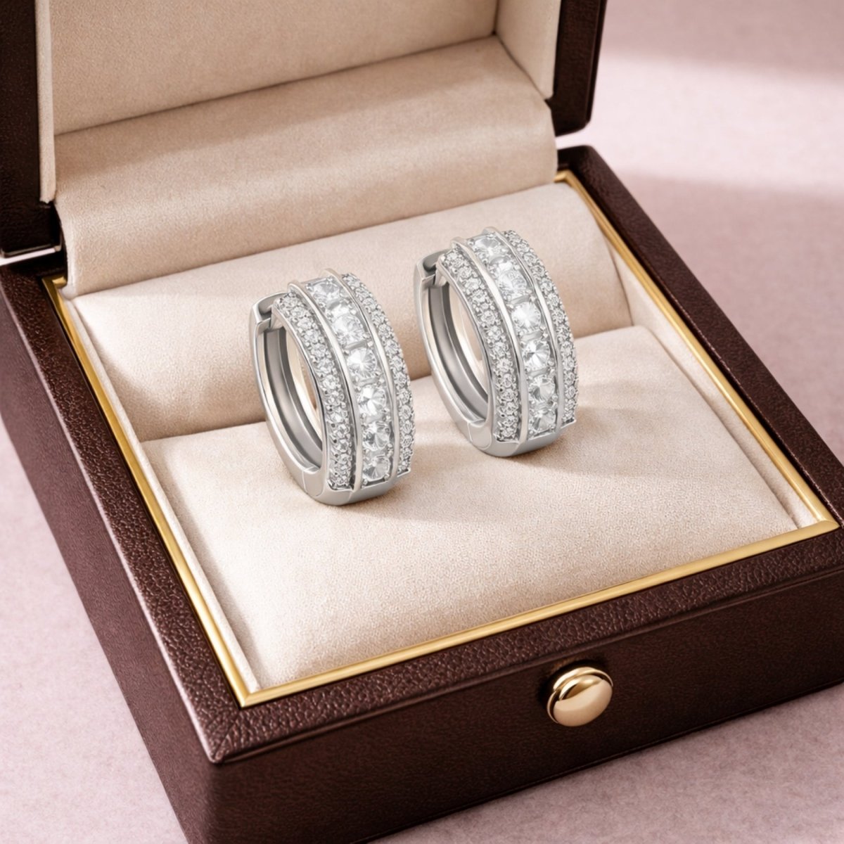 Kouvr sterling silver and diamond huggie hoop earrings presented elegantly inside a premium brown and cream leather jewelry box.