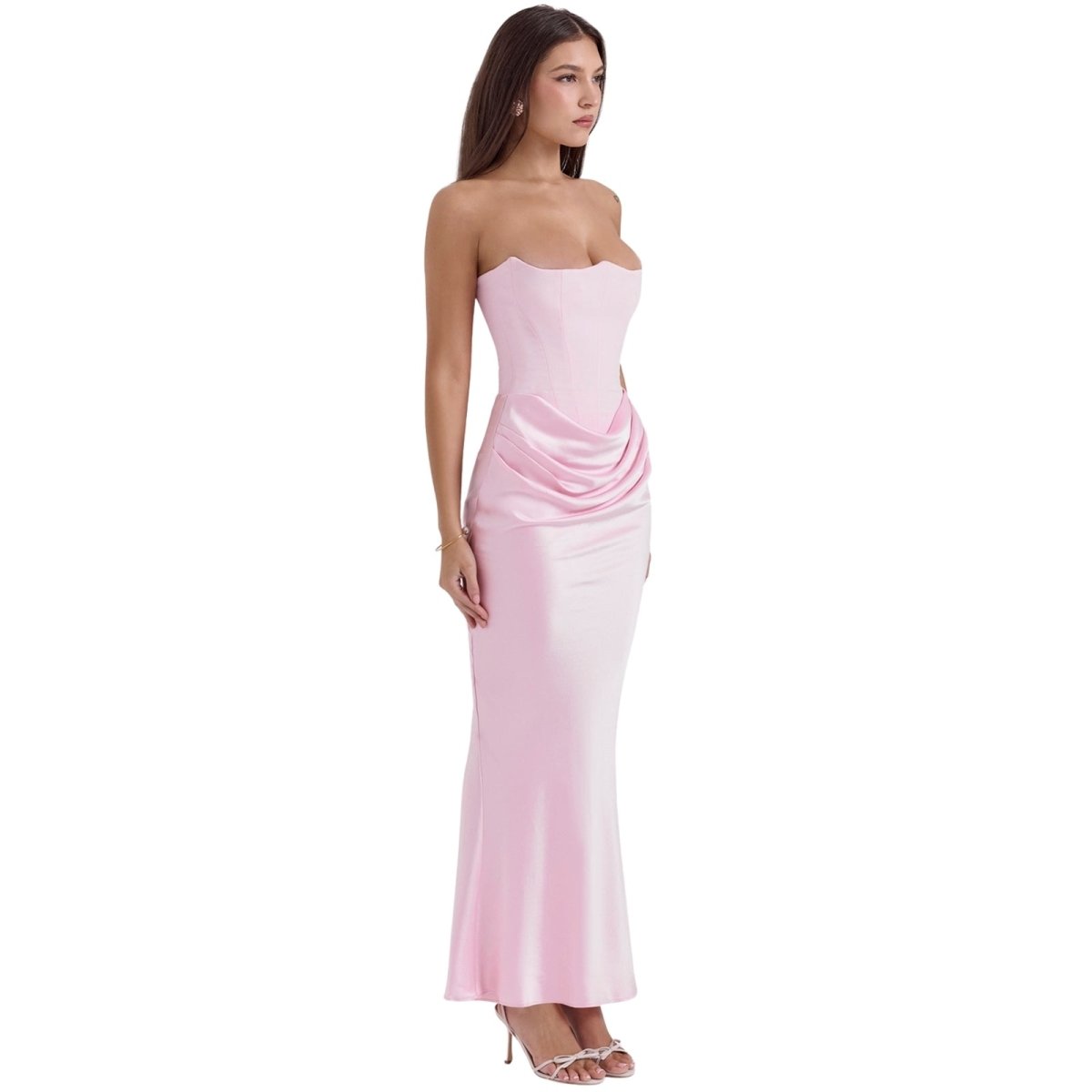 Woman wearing a strapless pink Kouvr evening gown on a white background