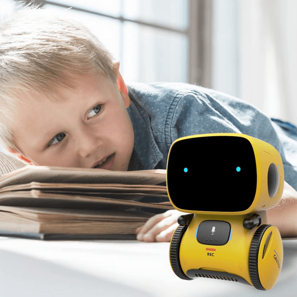 A young boy reading a book next to his yellow Kouvr robot, portraying it as a quiet learning companion.