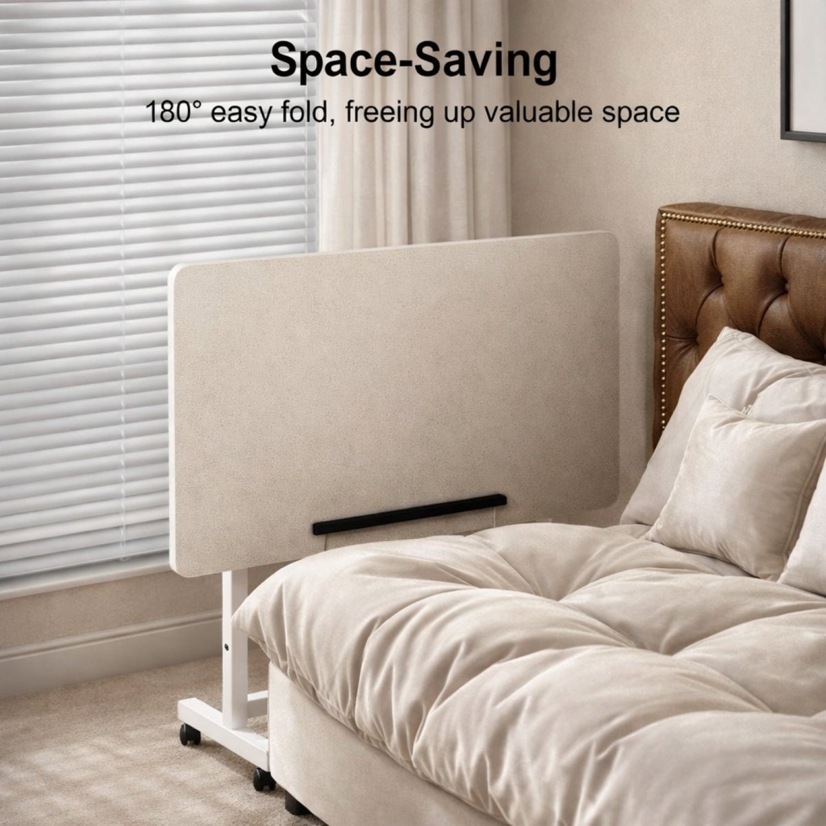 The Kouvr mobile desk with its tabletop folded vertically and stored next to a bed, illustrating its space-saving 180-degree fold feature.