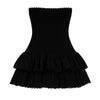 Model wearing Kouvr Starla black strapless smocked mini dress with tiered eyelet skirt