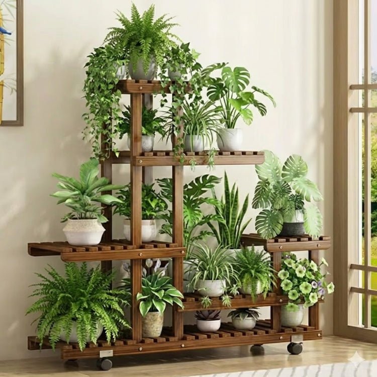 A tall, dark wood tiered plant shelf fully decorated with over fifteen assorted green houseplants, including ferns and monsteras, positioned next to a window.