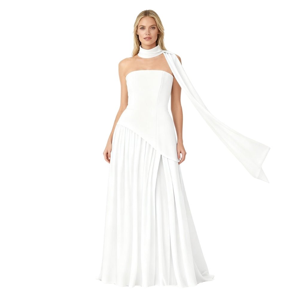 Woman wearing a white Kouvr one-shoulder gown with a flowing fabric on a white background