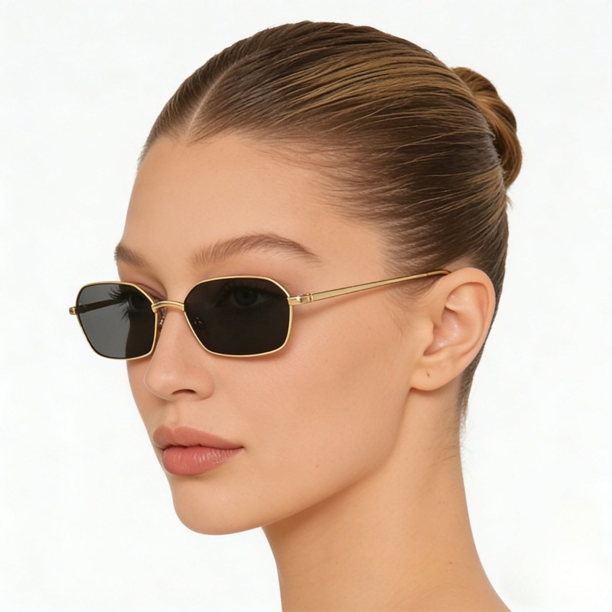 Side profile view of a woman wearing Kouvr's The Liezel slim gold sunglasses to display the temple arms and minimalist design.