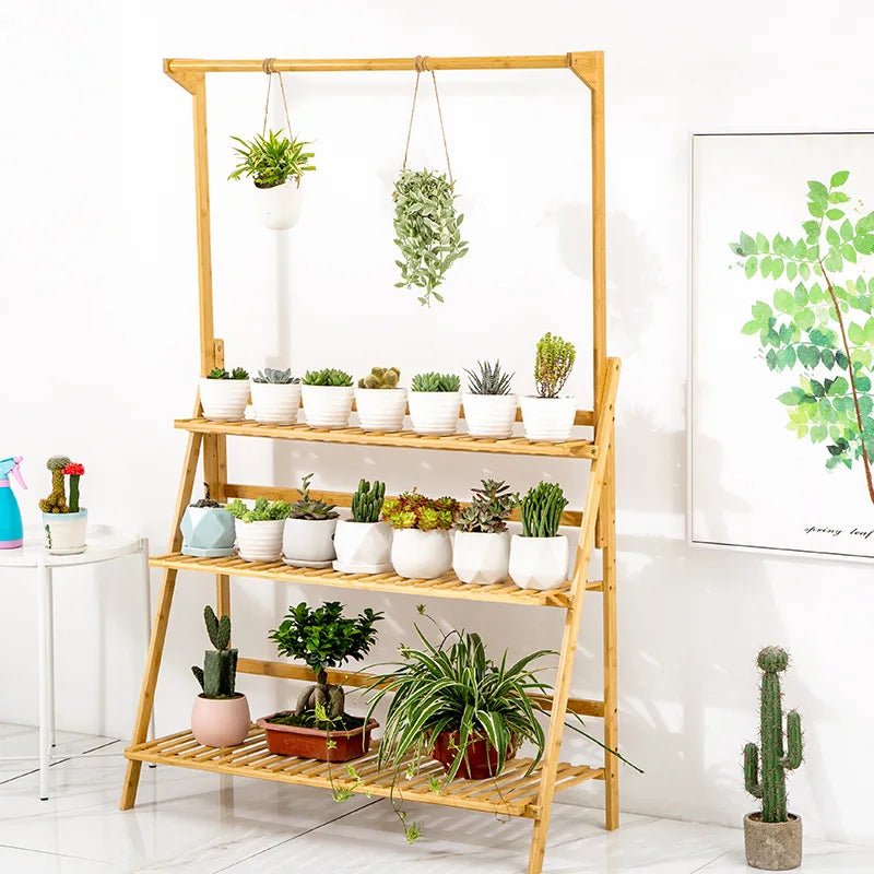 A minimalist interior scene featuring the Kouvr tiered plant holder displaying a curated collection of small cacti and hanging string-of-pearls.