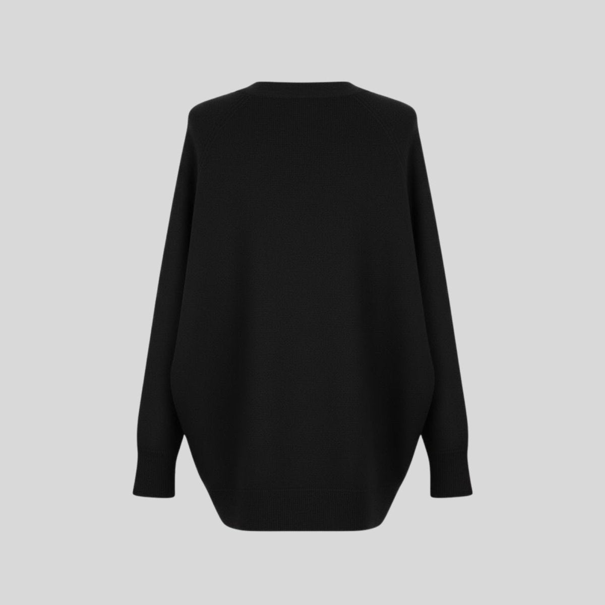 Back view flatlay of the Kouvr Fashion Tina black oversized sweater highlighting its clean construction and minimalist design.