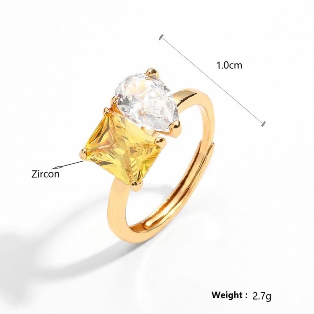 Product details of the Kouvr Toi et Moi ring, showing its 1.0cm setting width, 2.7g weight, and identifying the stones as high-quality Zircon.
