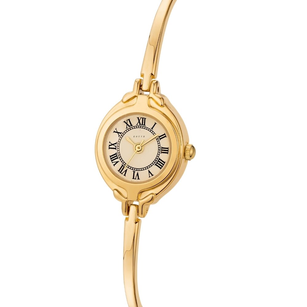 Gold Kouvr wristwatch with a white face and black Roman numerals on a white background