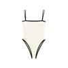 White Kouvr swimsuit with thin straps on a black background
