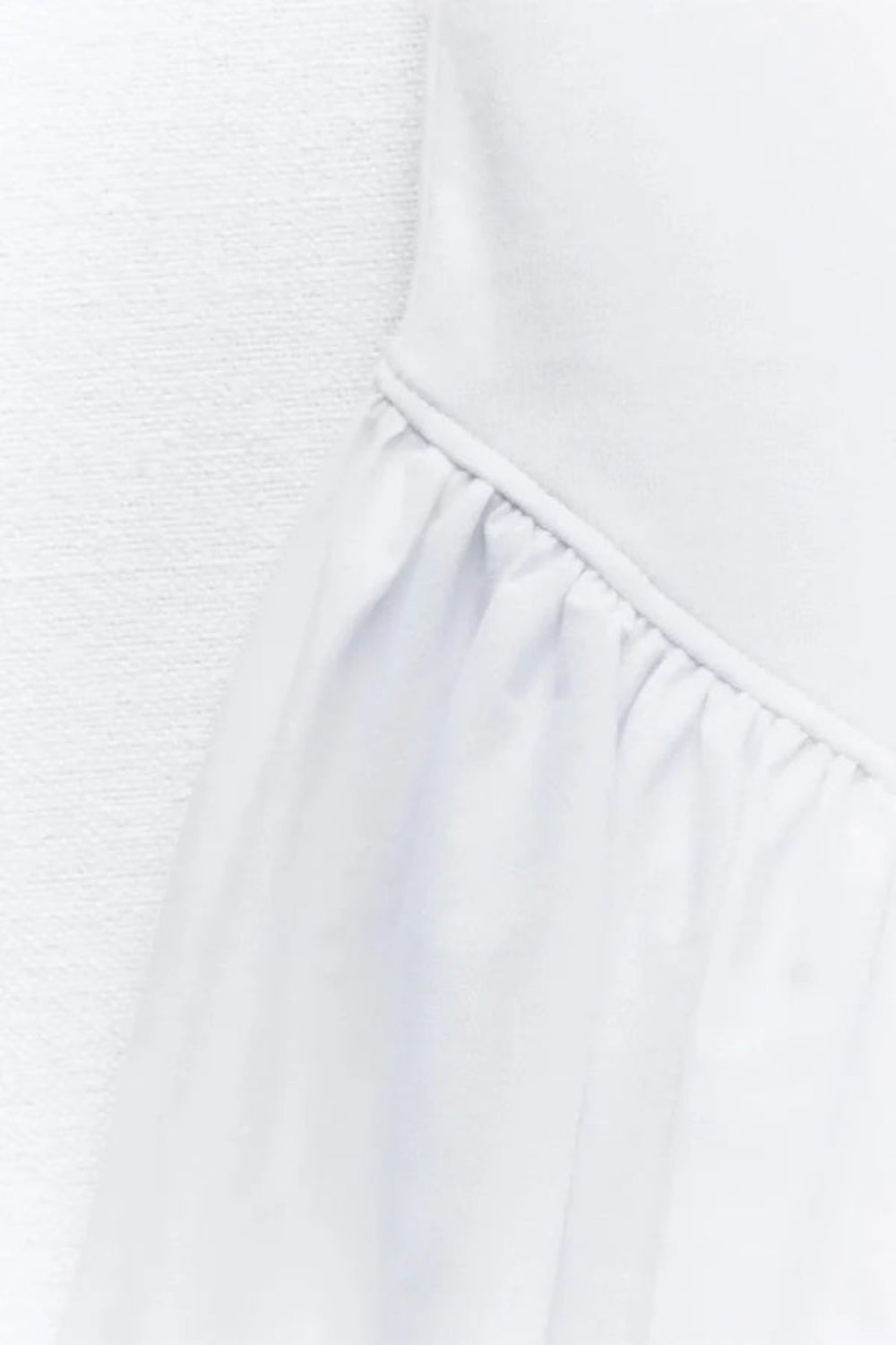 Model wearing the Kouvr white bubble hem mini dress with spaghetti straps