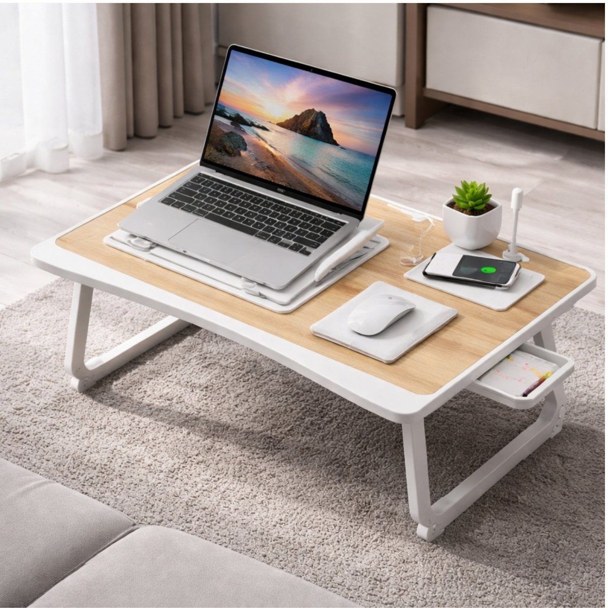 Kouvr white lap desk used on a carpeted floor, displaying the anti-slip baffle preventing the laptop from sliding while tilted.