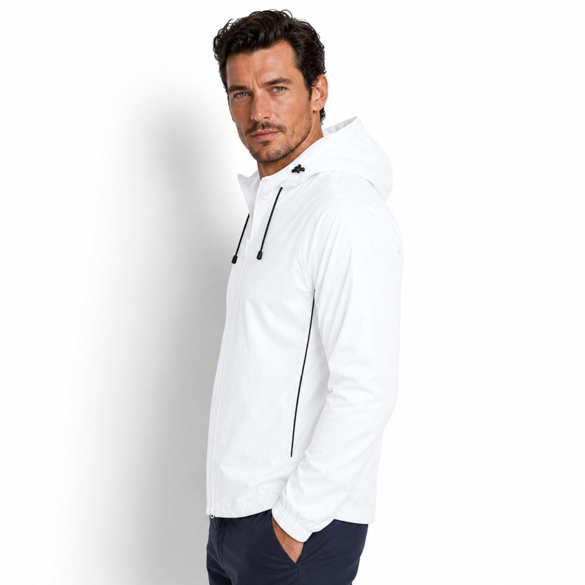 Side profile of man wearing white athleisure jacket with black contrast piping by Kouvr