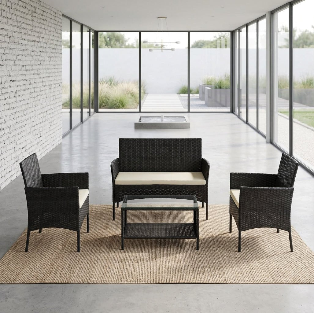 4-Piece espresso wicker patio furniture set styled in a modern indoor sunroom featuring a loveseat, two armchairs, and a glass coffee table.