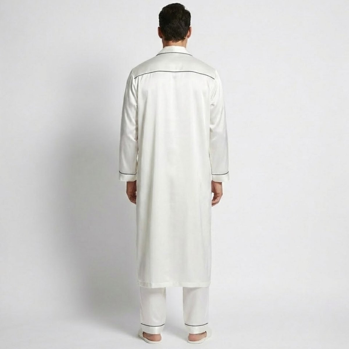 Back view of a model wearing the Kouvr Wilson Set white silk long robe over matching pajama pants.