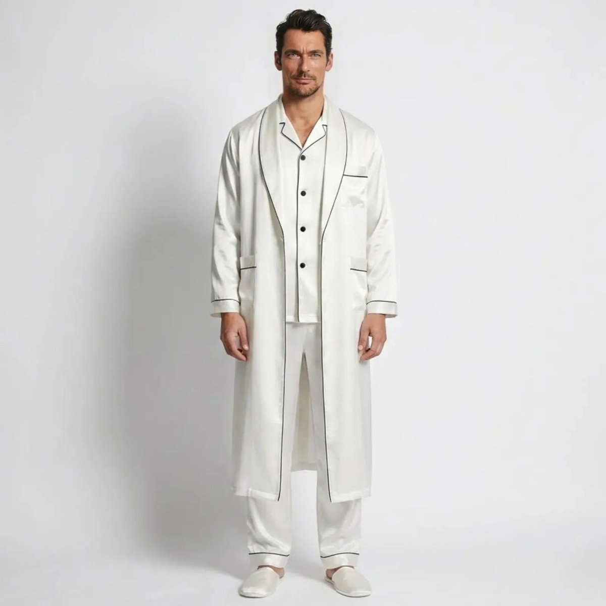 Model wearing the Kouvr Wilson Set men's three-piece white silk pajama set with matching long robe, front view.