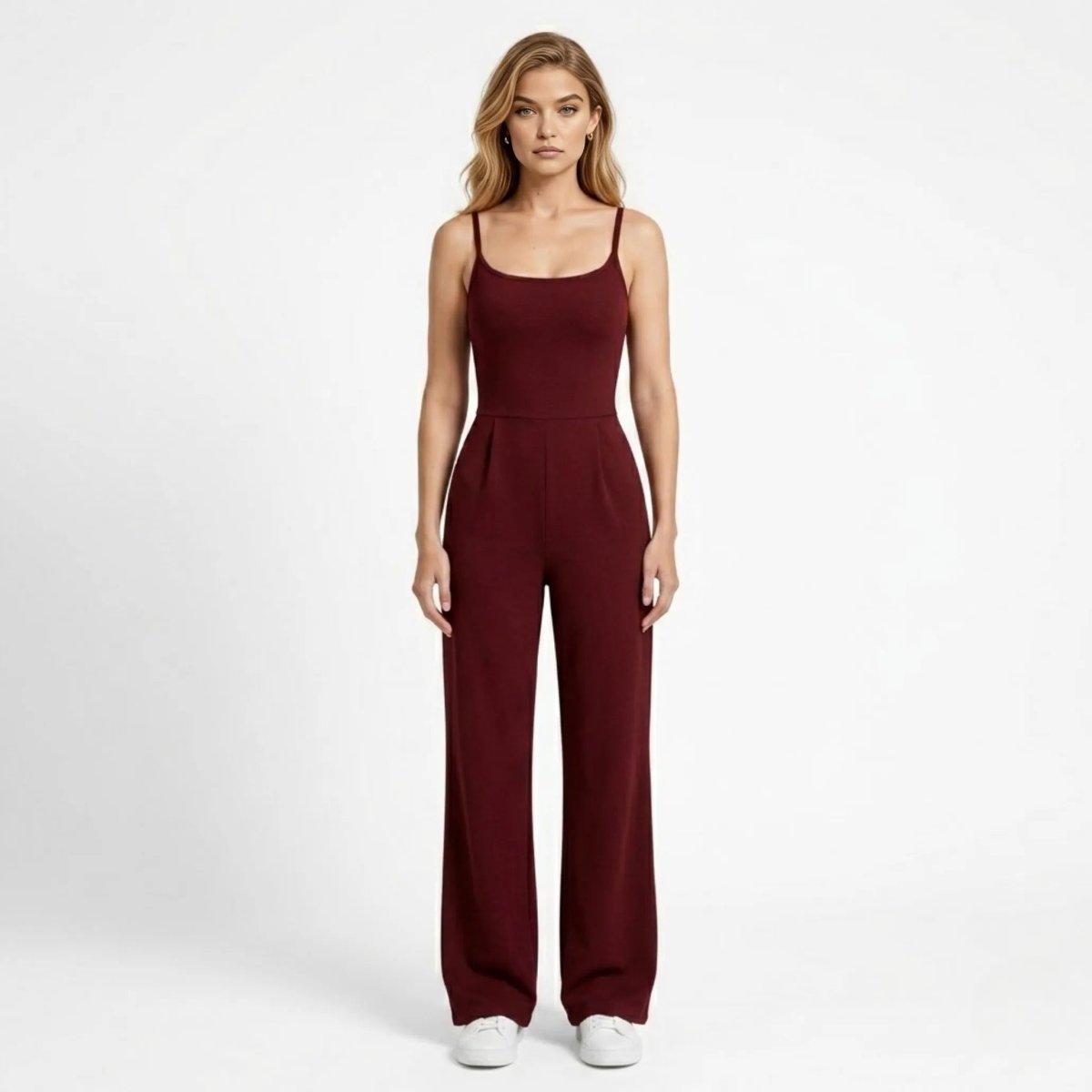 Woman wearing Kouvr wine red wide leg sleeveless jumpsuit facing forward in a clean studio setting.