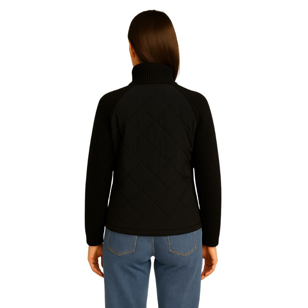 Woman wearing the Kouvr Fashion black quilted jacket with cable knit sleeves and a funnel neck collar, styled for a casual city look