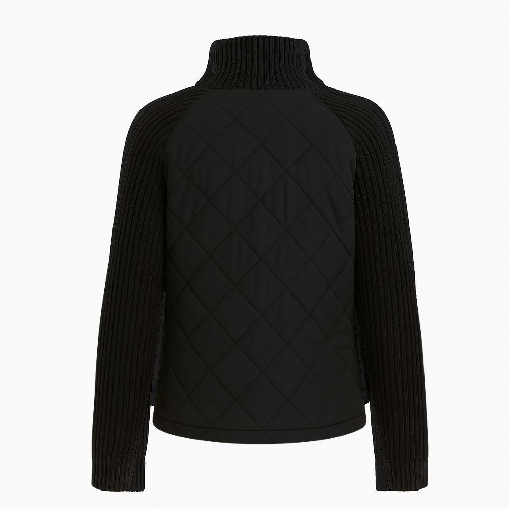 Woman wearing the Kouvr Fashion black quilted jacket with cable knit sleeves and a funnel neck collar, styled for a casual city look