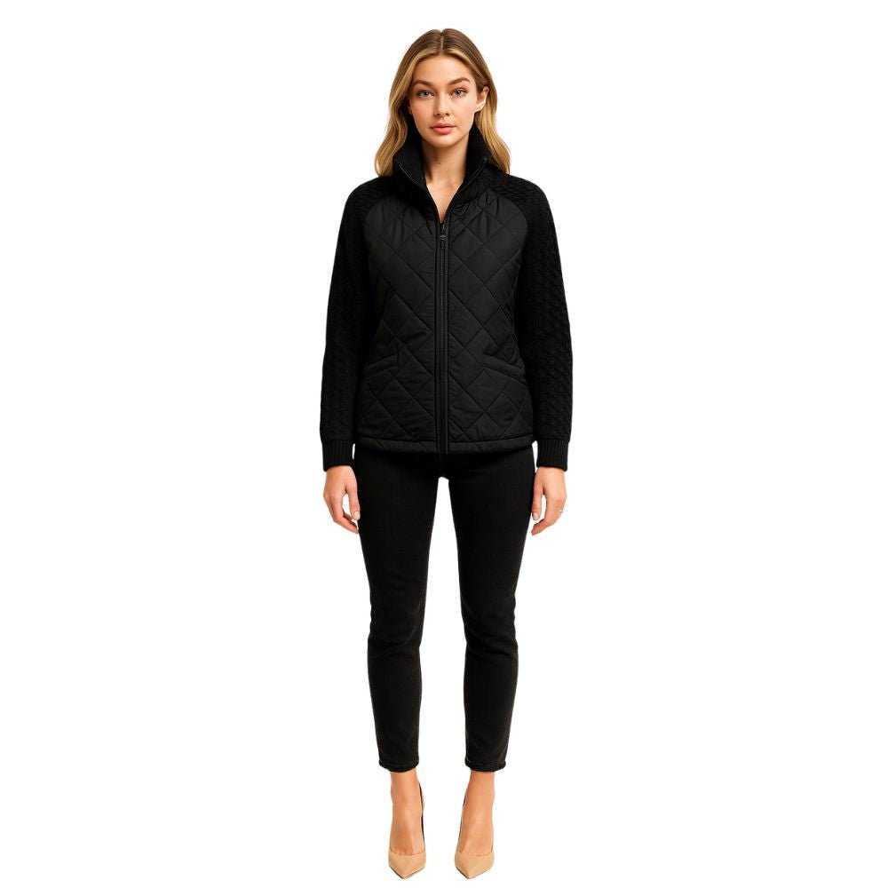 Woman wearing the Kouvr Fashion black quilted jacket with cable knit sleeves and a funnel neck collar, styled for a casual city look