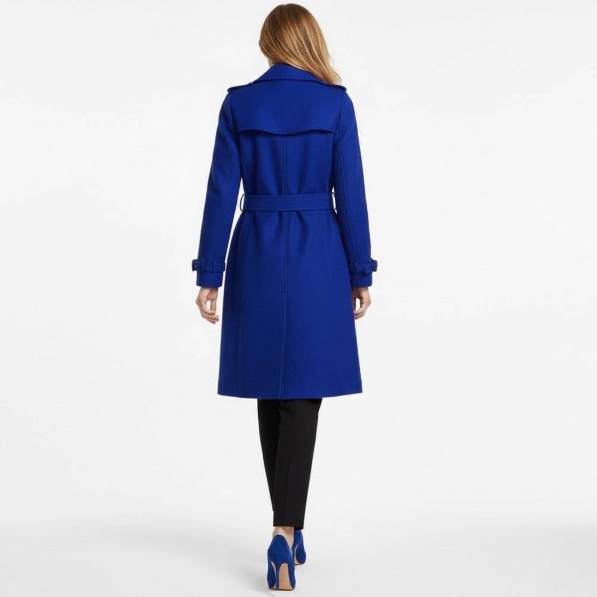 Back view of the belted blue wool trench coat by Kouvr Fashion, showing the storm flap and single vent details.