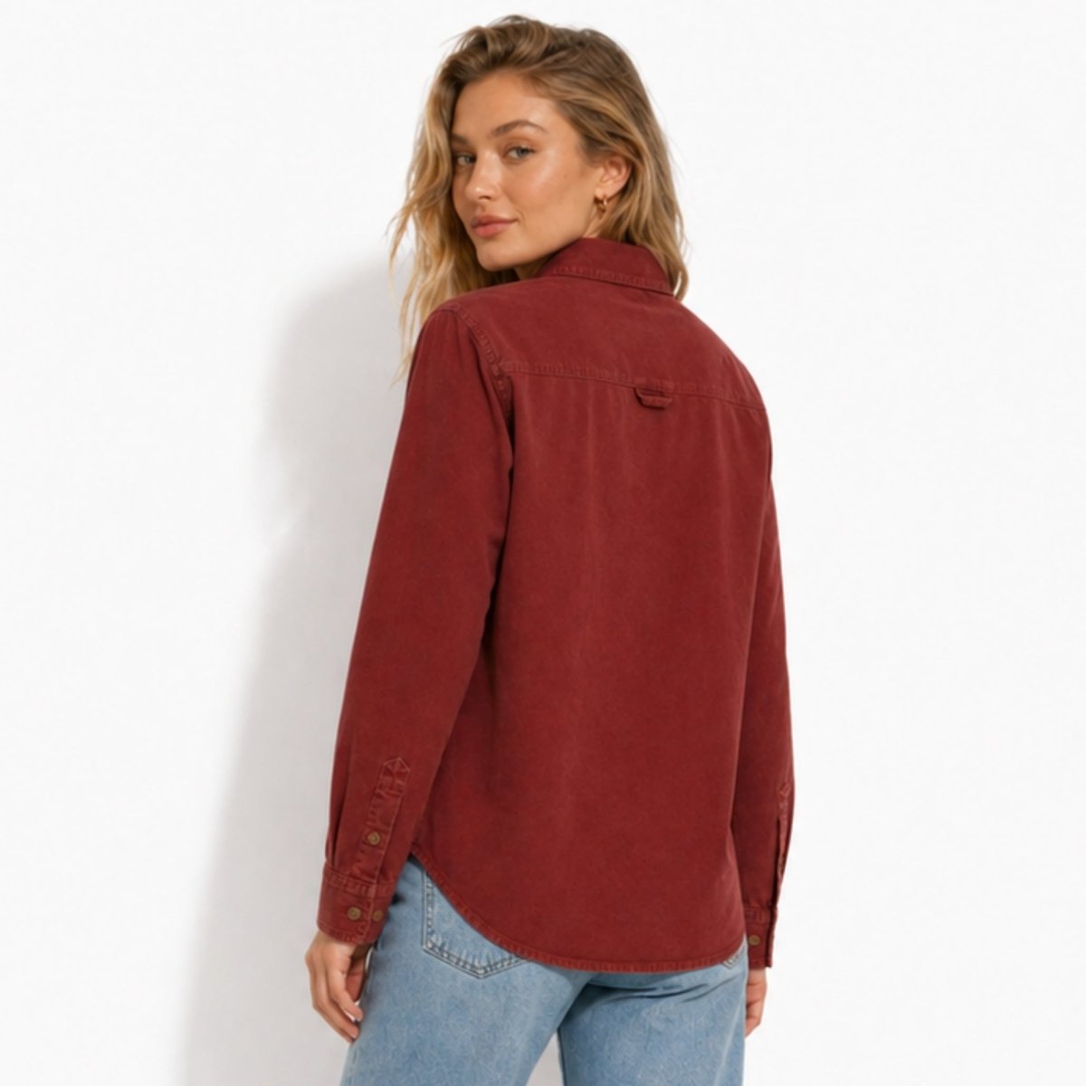 Back view of the Kouvr women's fall layering top in red, featuring a back yoke with locker loop detail.