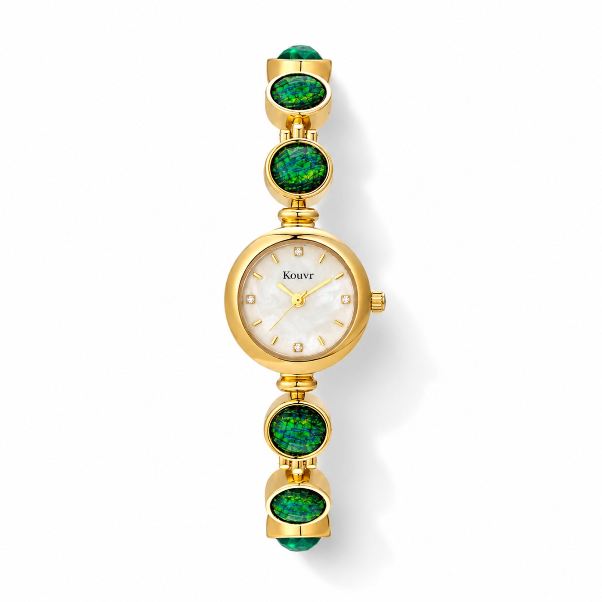 High-resolution flat lay view of the Kouvr gold women's watch highlighting the bright mother of pearl dial, crystal accents, and vibrant green stones.