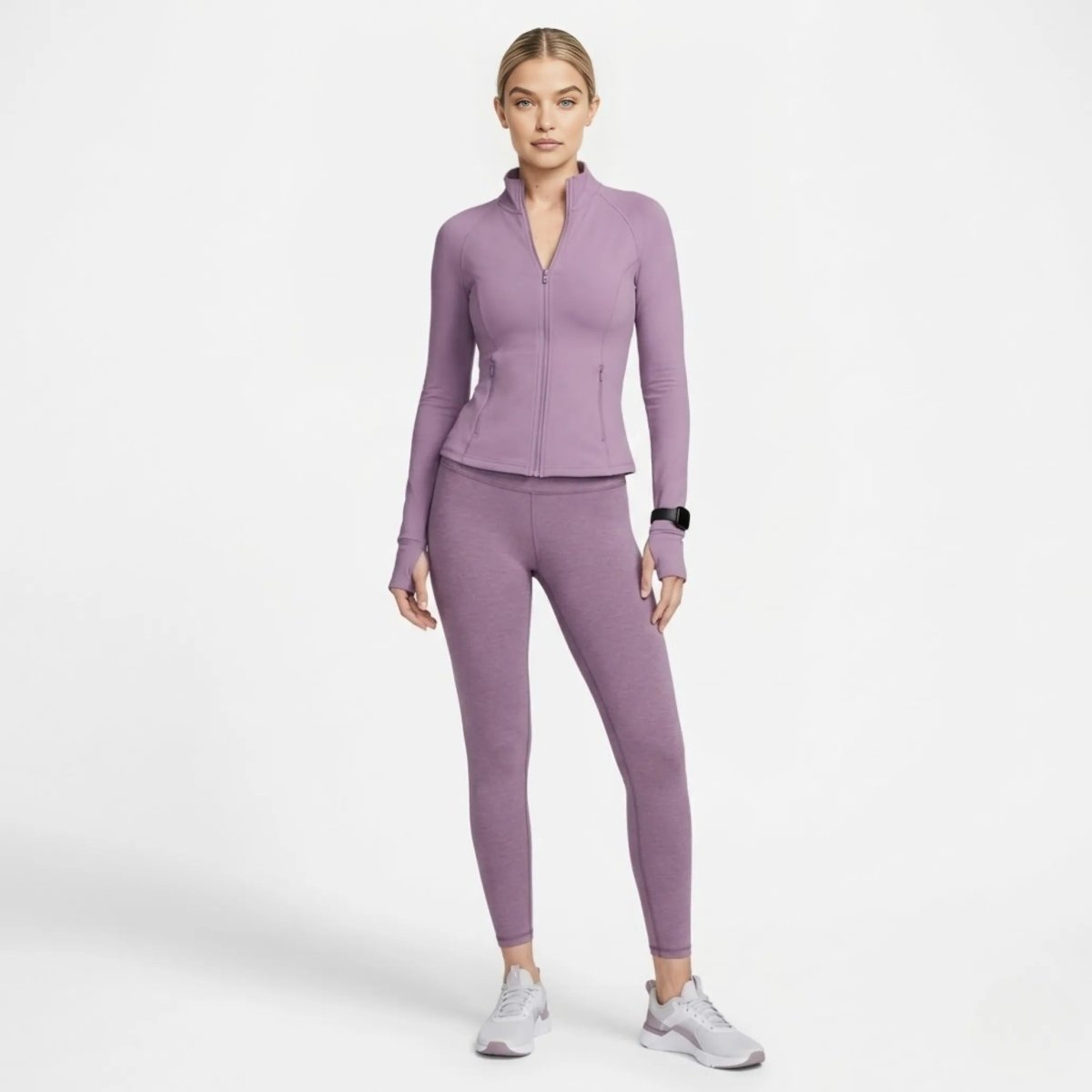 Full body lifestyle shot of woman modeling Kouvr purple sculpting activewear jacket and matching leggings