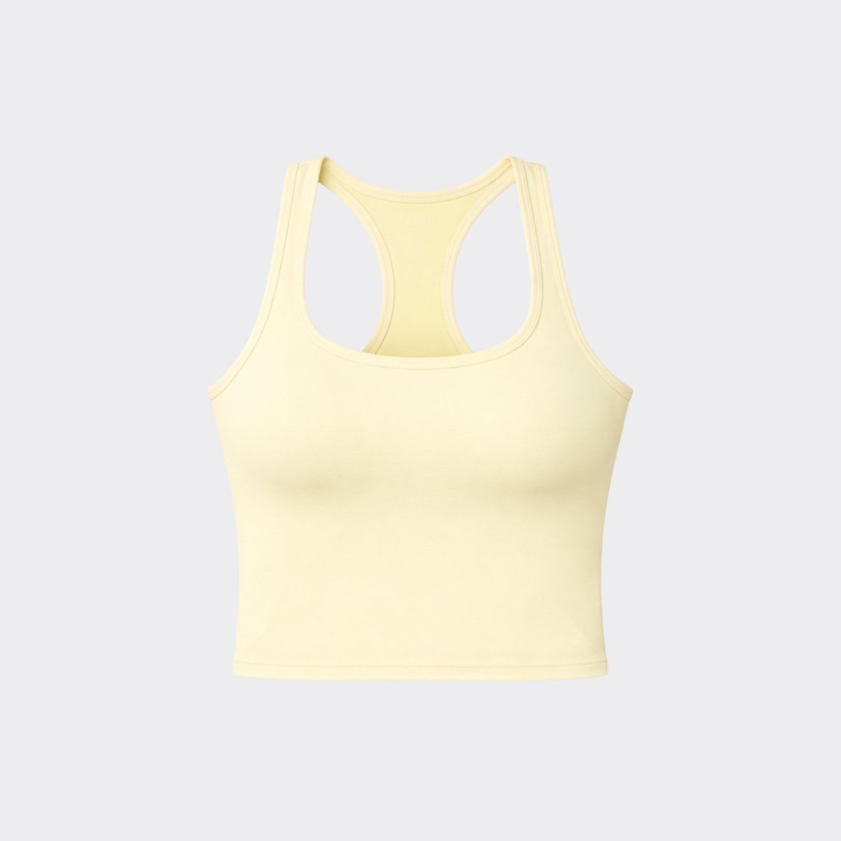 Flat lay front view of Kouvr butter yellow scoop neck racerback cropped activewear top