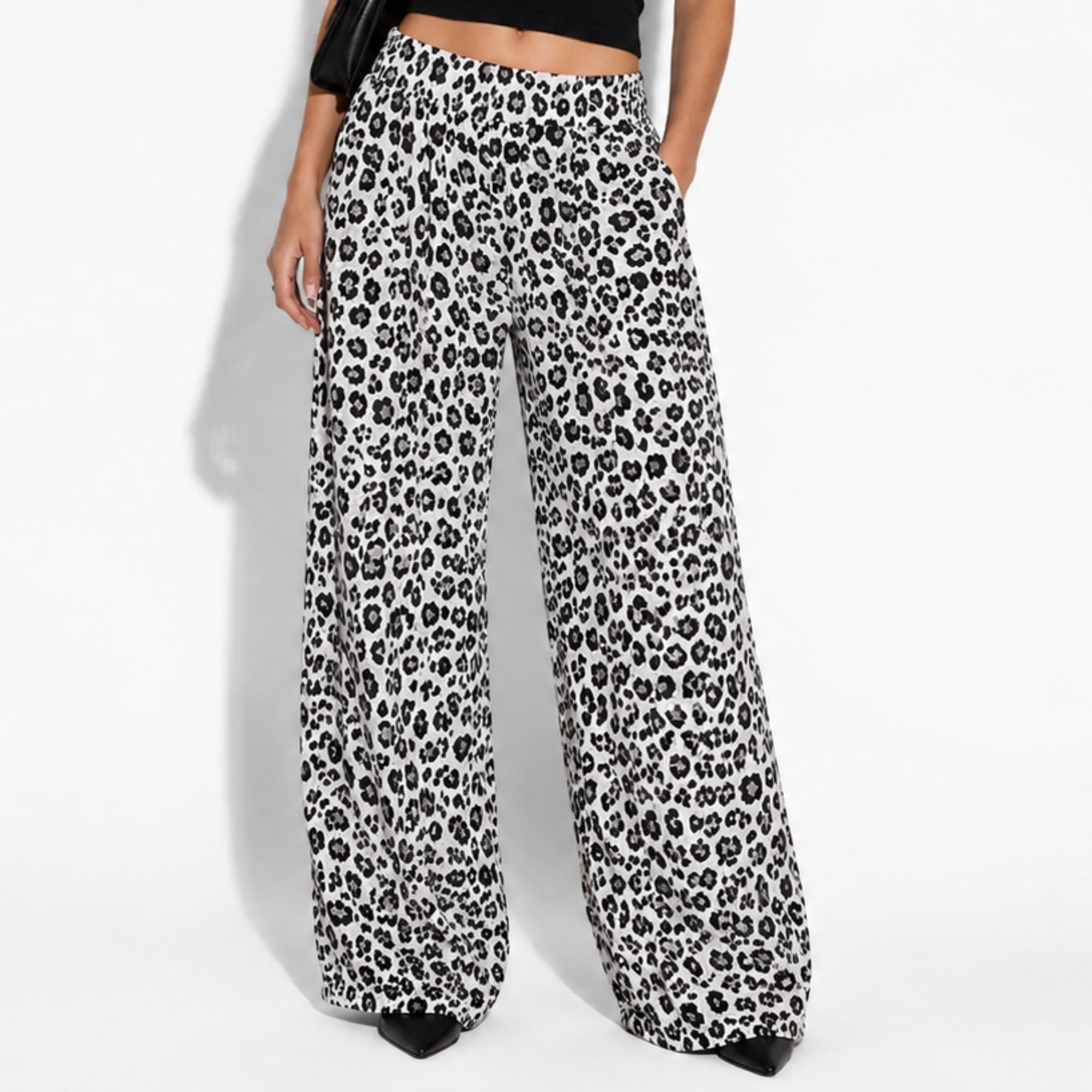 Close up of women's luxury leopard print wide leg pants showing flowy high waisted drape and relaxed fit
