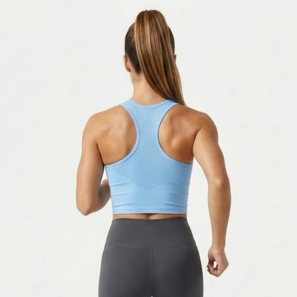 Back view of light blue seamless racerback sports bra with breathable mesh detail