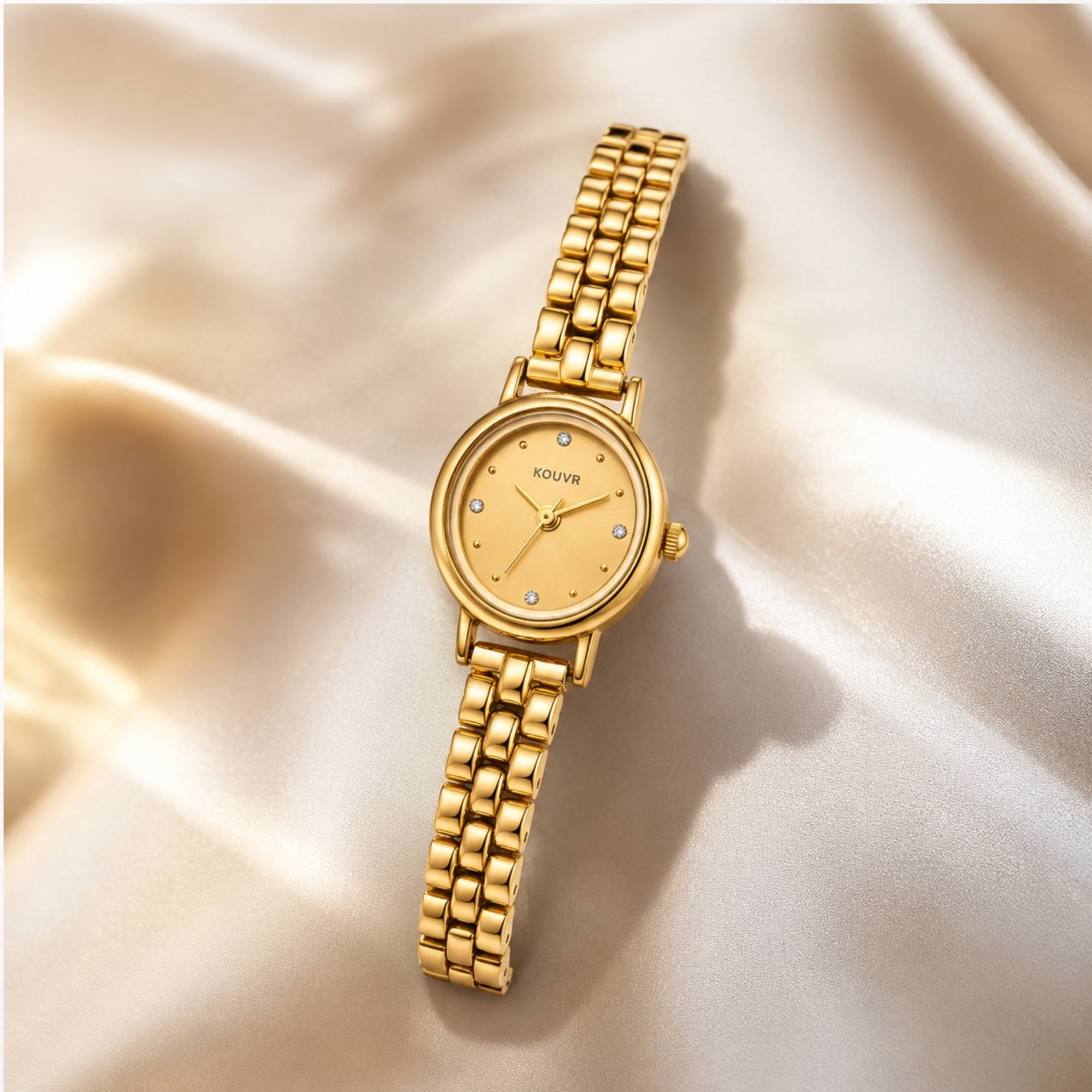 Beautiful women's gold vintage style watch resting gracefully on luxurious folded champagne silk fabric.