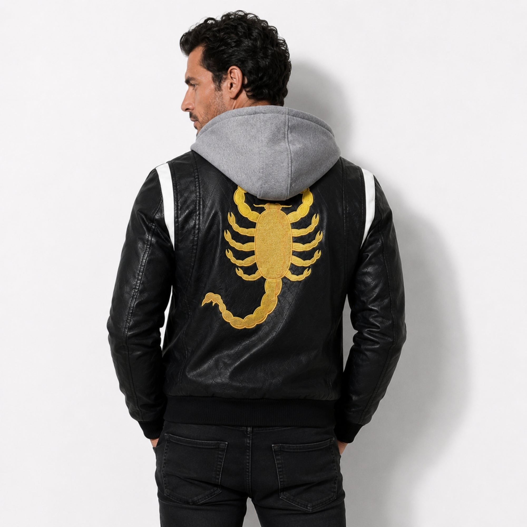 Back view of the Kouvr black leather motorcycle jacket showcasing the large, high-stitch golden embroidered scorpion design.