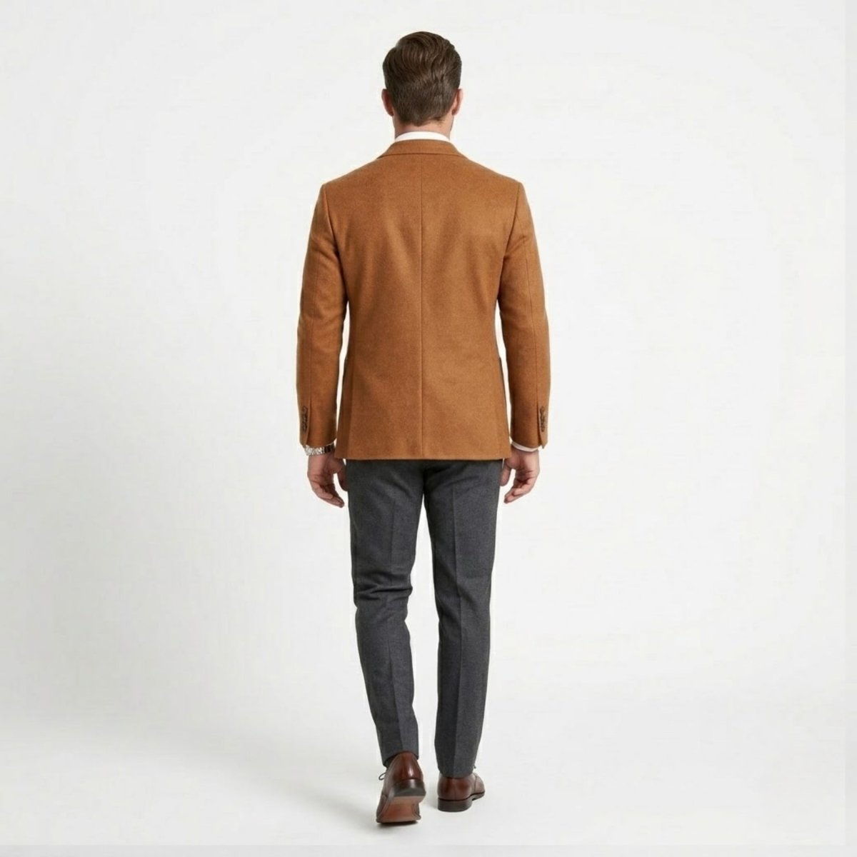 Back profile of male model walking in tailored camel jacket