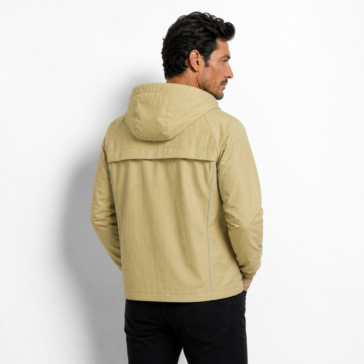 Back view of the Kouvr light army green lightweight windbreaker showing ventilated back yoke design and hood.