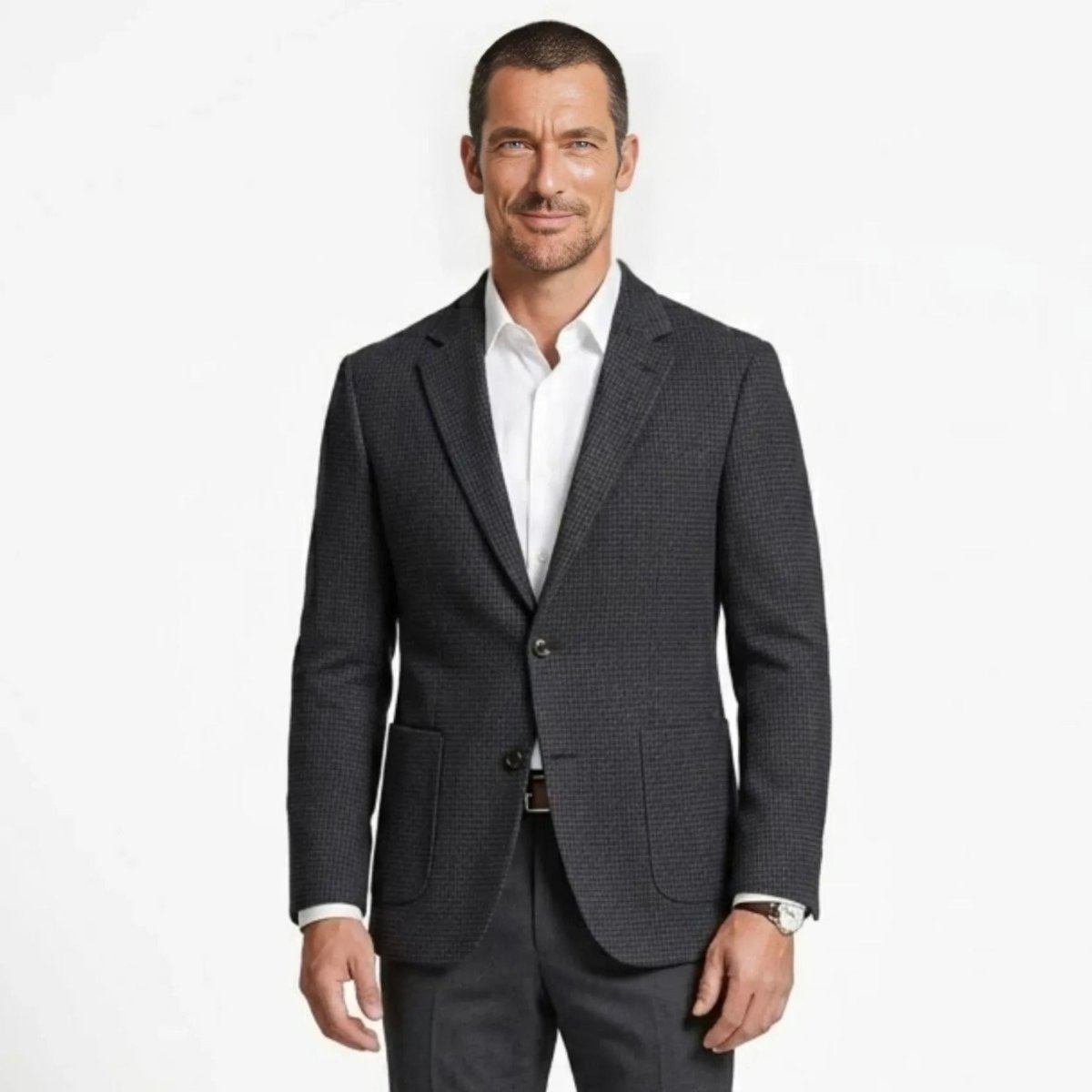 Close up front view of a man wearing a plaid textured tailored blazer over a white dress shirt.