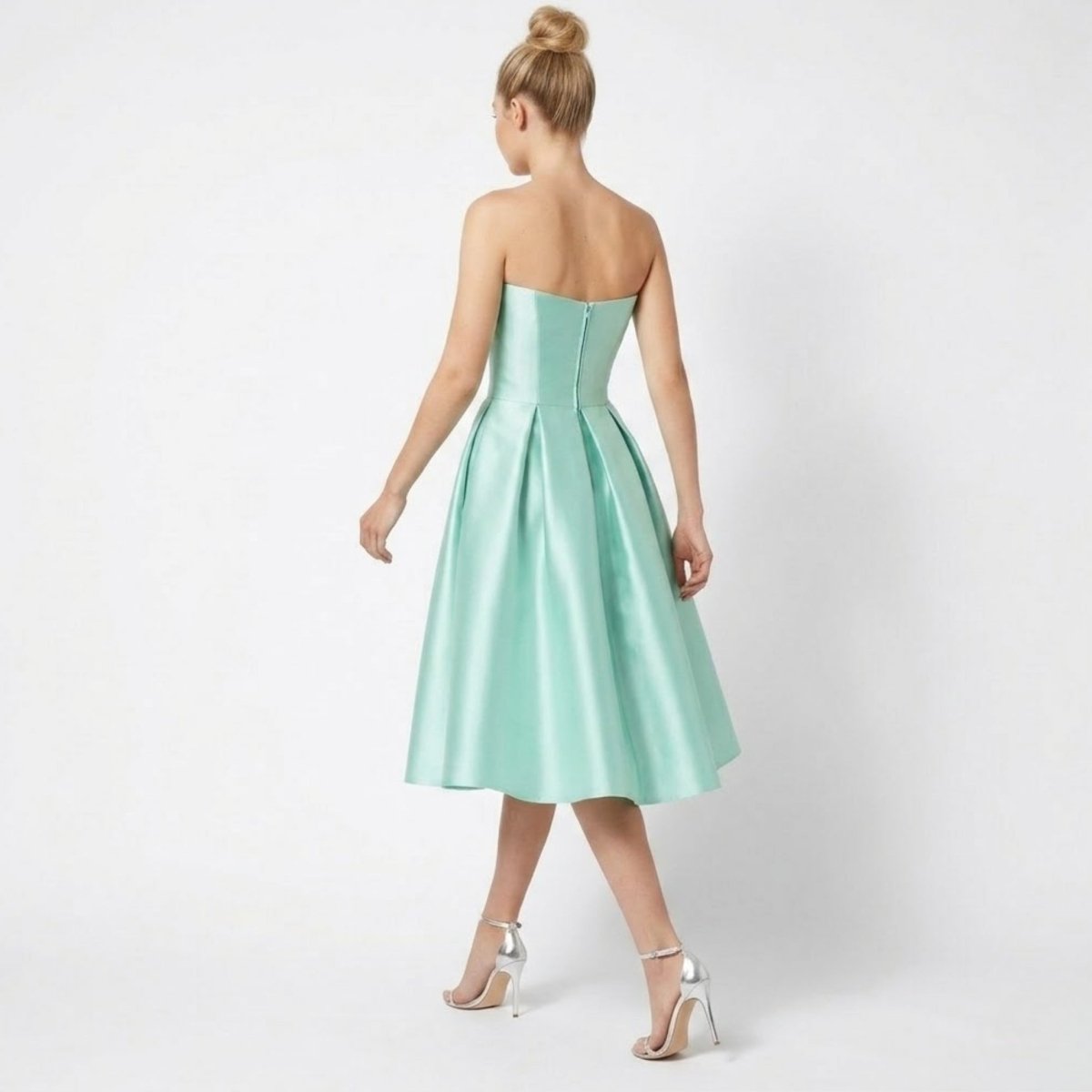 Back view of Kouvr mint green satin midi dress showing invisible zipper and pleated A-line skirt