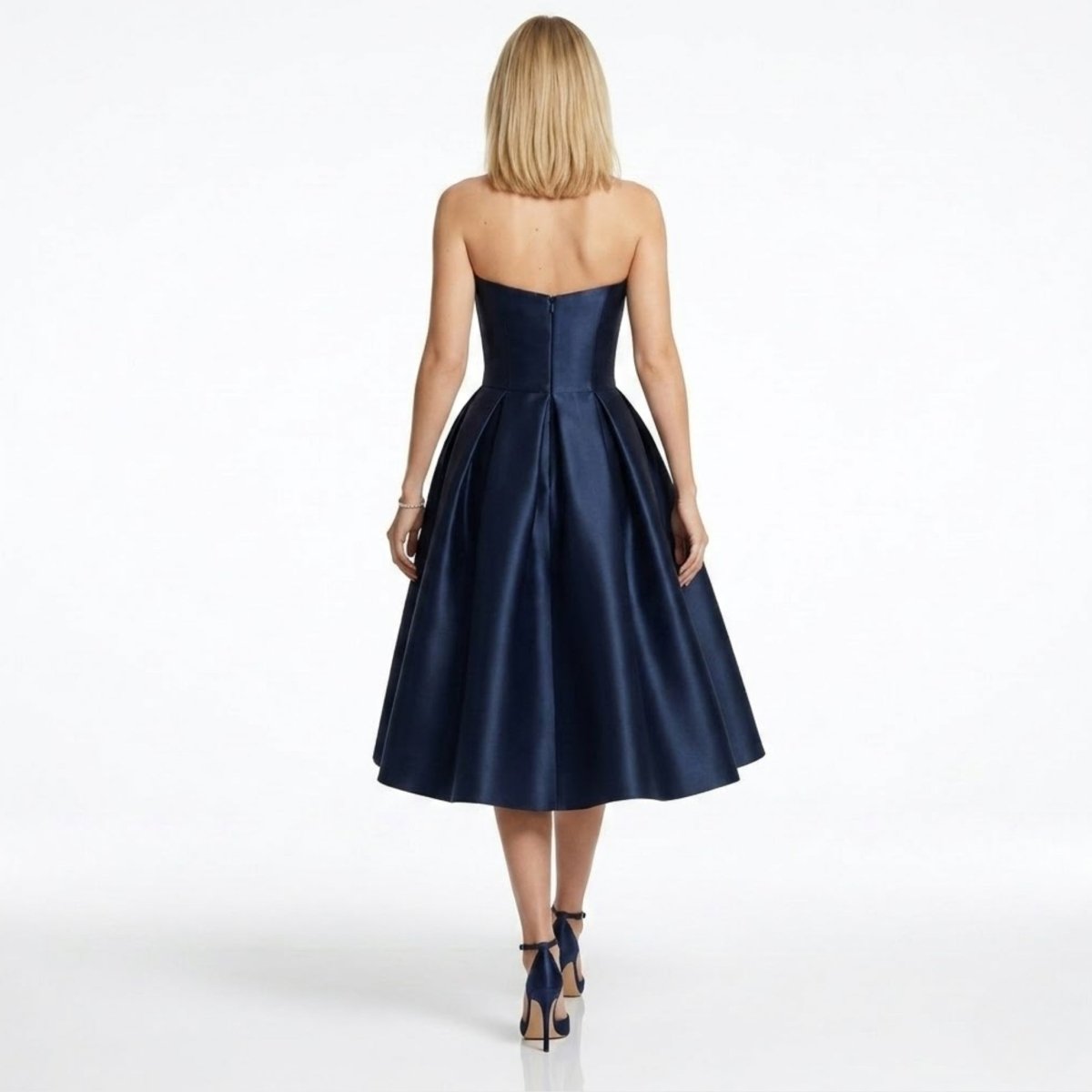 Back detail of navy satin formal party dress showing concealed zipper and pleated A-line skirt.