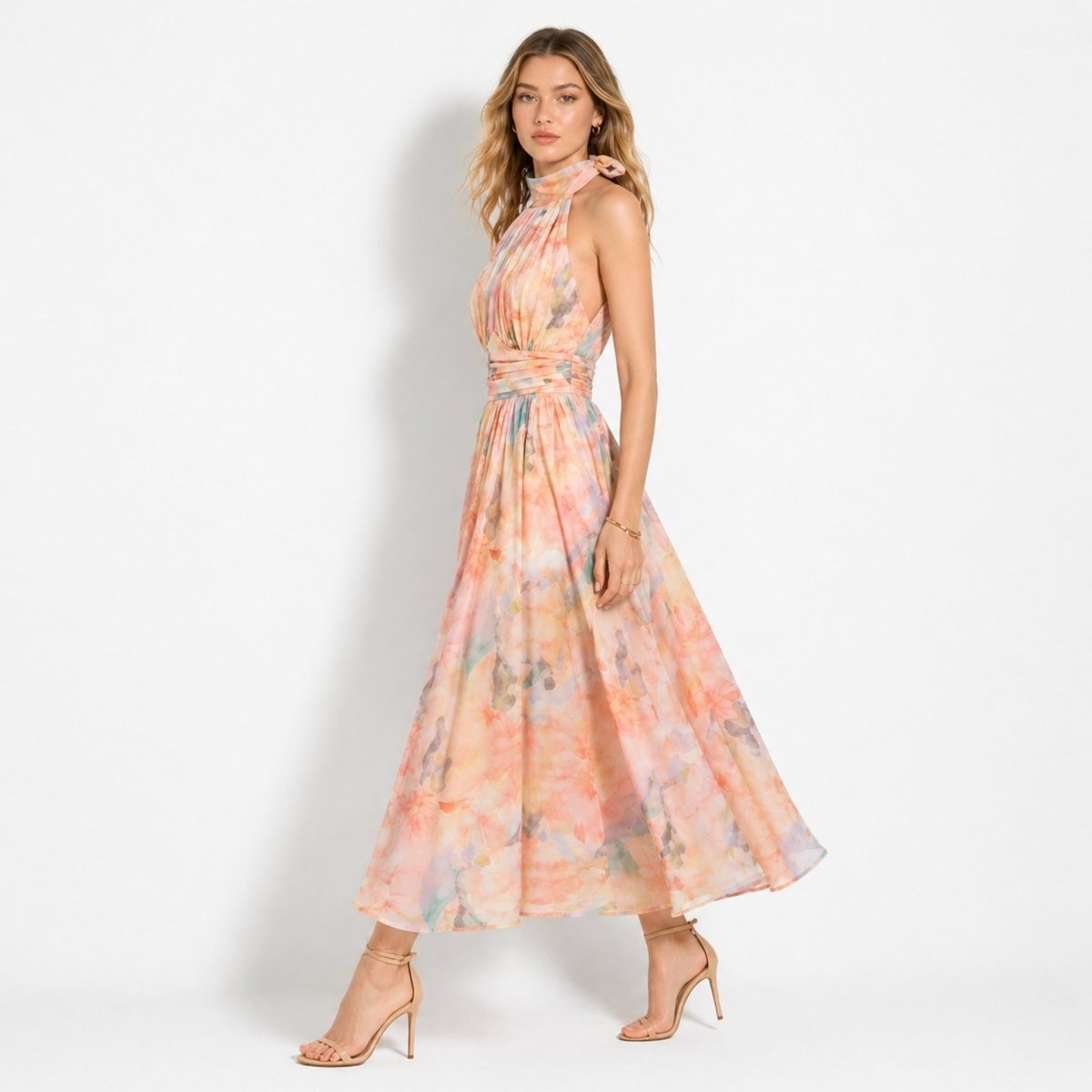 Side profile of woman walking in Kouvr flowing chiffon pastel floral open back midi dress