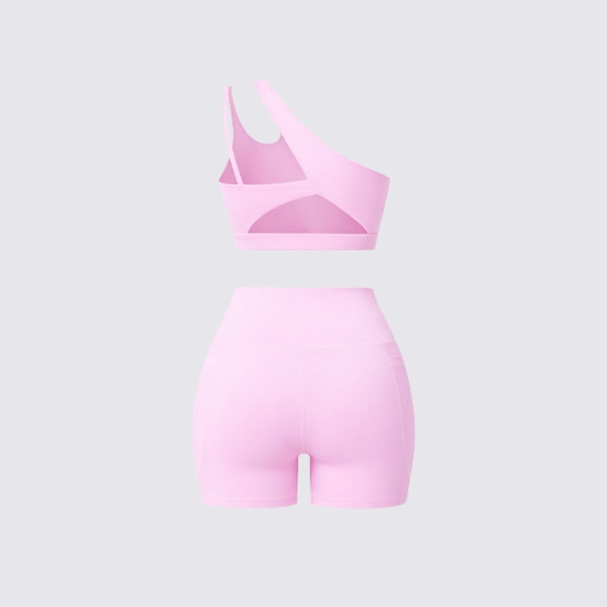 Back flatlay view of a pastel pink athletic set showcasing the unique strap design and back cutout of the sports bra