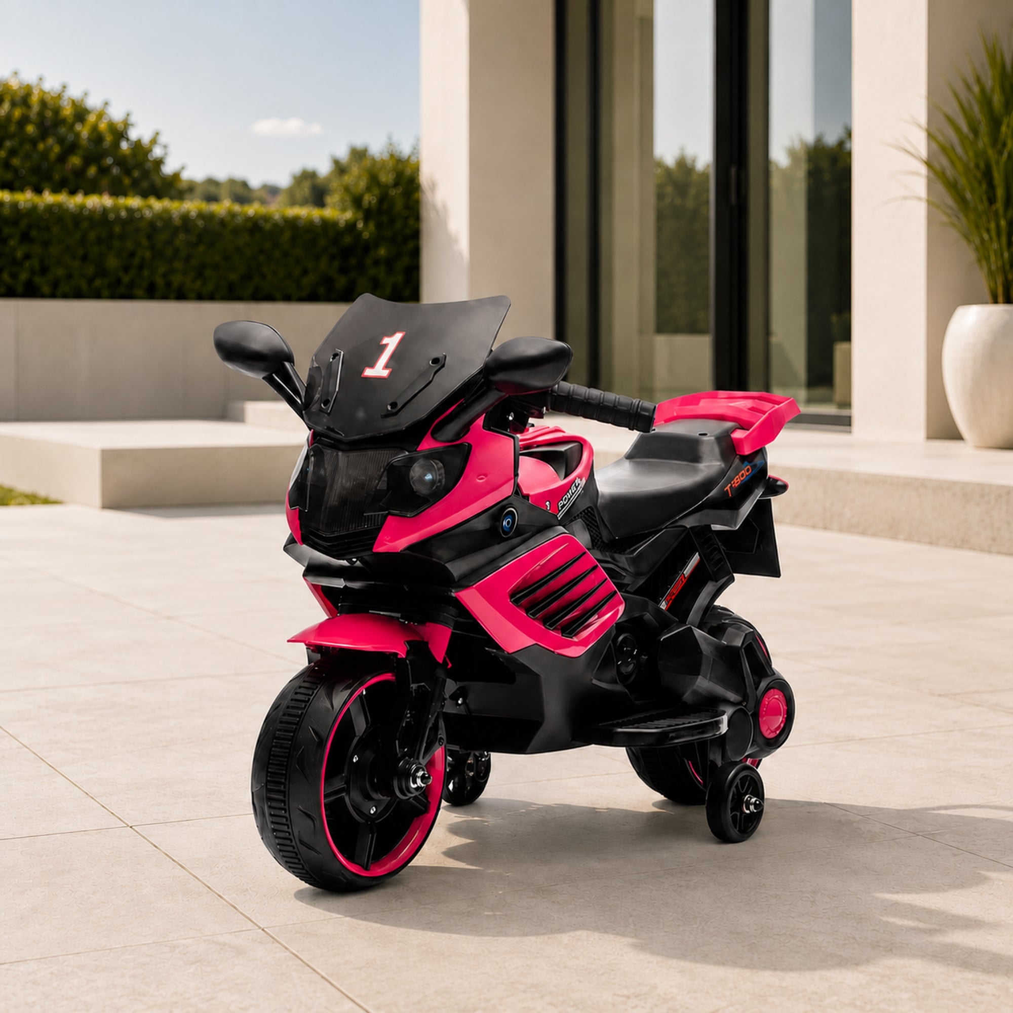 Pink luxury kids 6V electric motorcycle with training wheels parked elegantly on an outdoor patio.