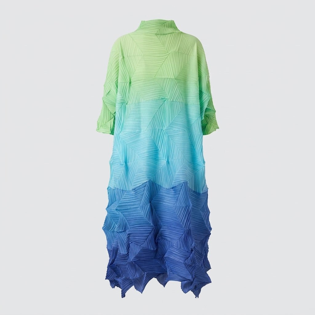 Full length studio shot of the Kouvr pleated architectural shift dress highlighting the green, teal, and royal blue color transition.