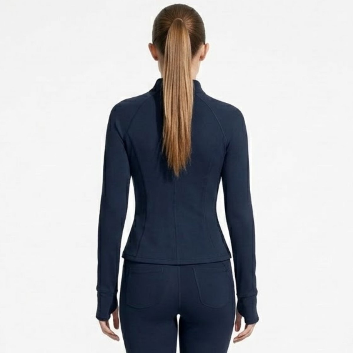 Back view of woman wearing navy blue fitted activewear track jacket with mock neck