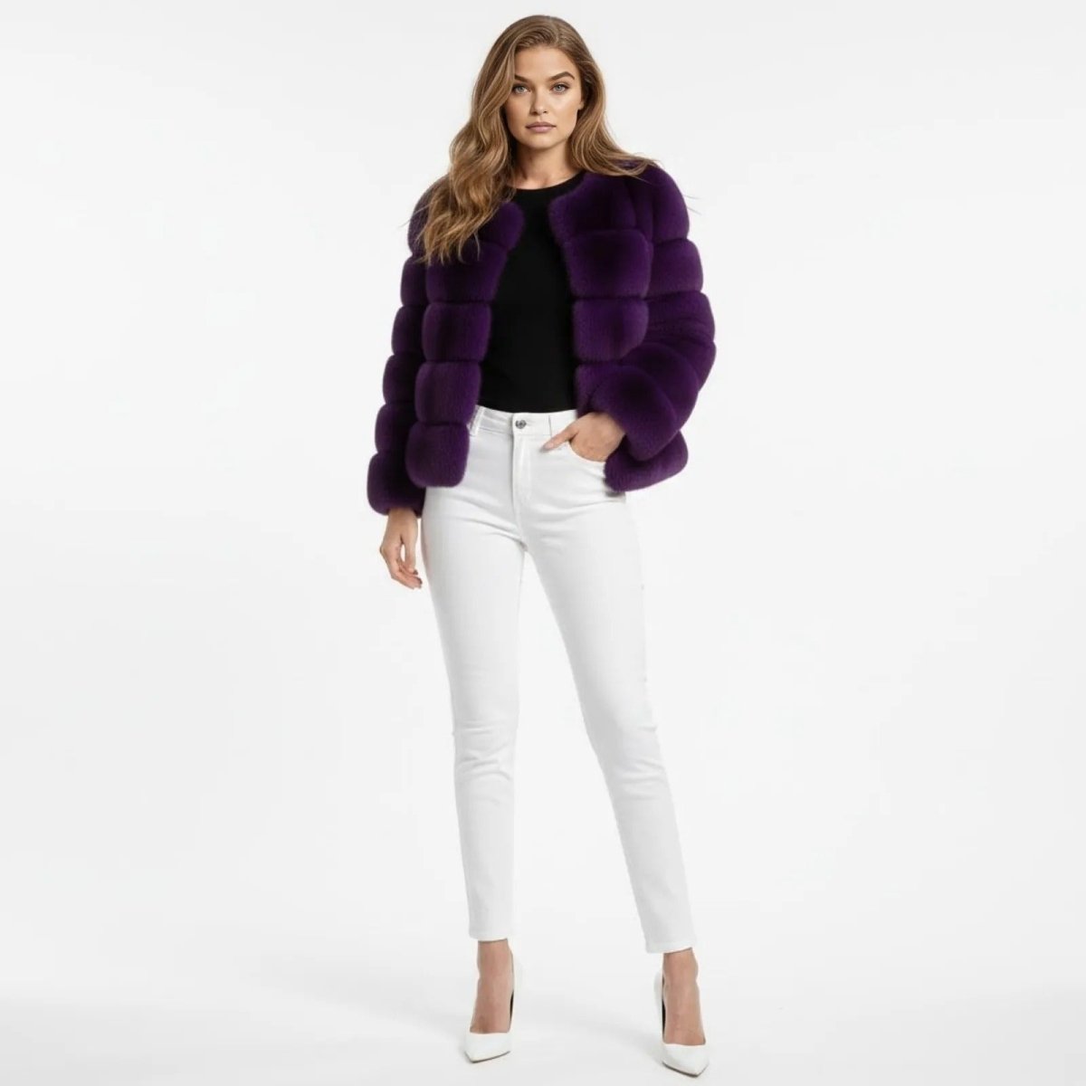 Model facing forward wearing the Kouvr Fashion purple paneled faux fur jacket with a black top, white jeans, and white high heels.