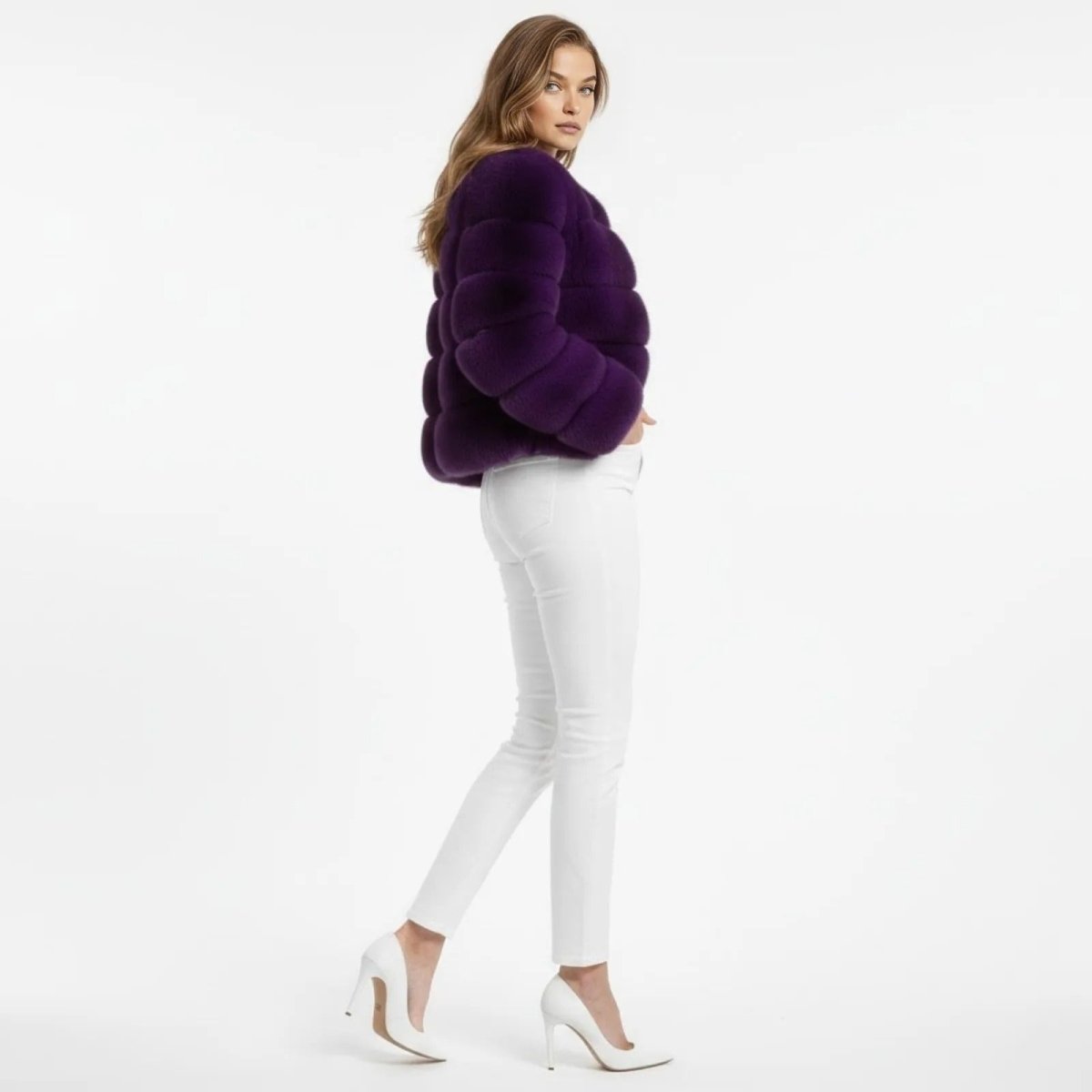 Model in a side profile pose showing the silhouette of the cropped purple faux fur jacket by Kouvr Fashion.
