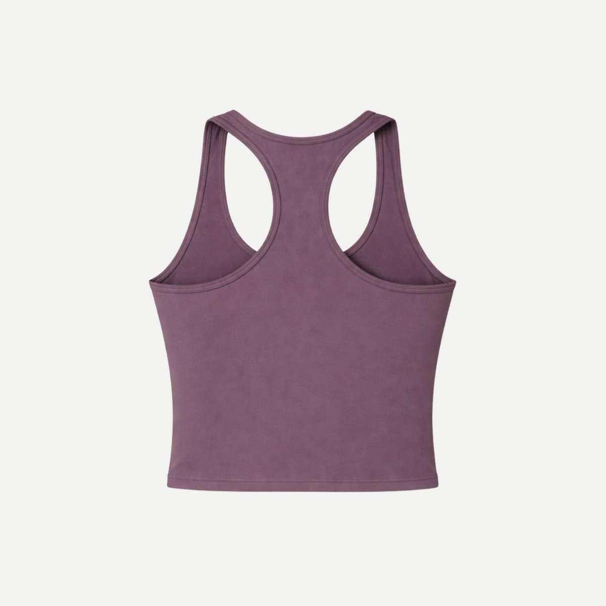 Flatlay back view of Kouvr purple racerback athletic crop top on white background.