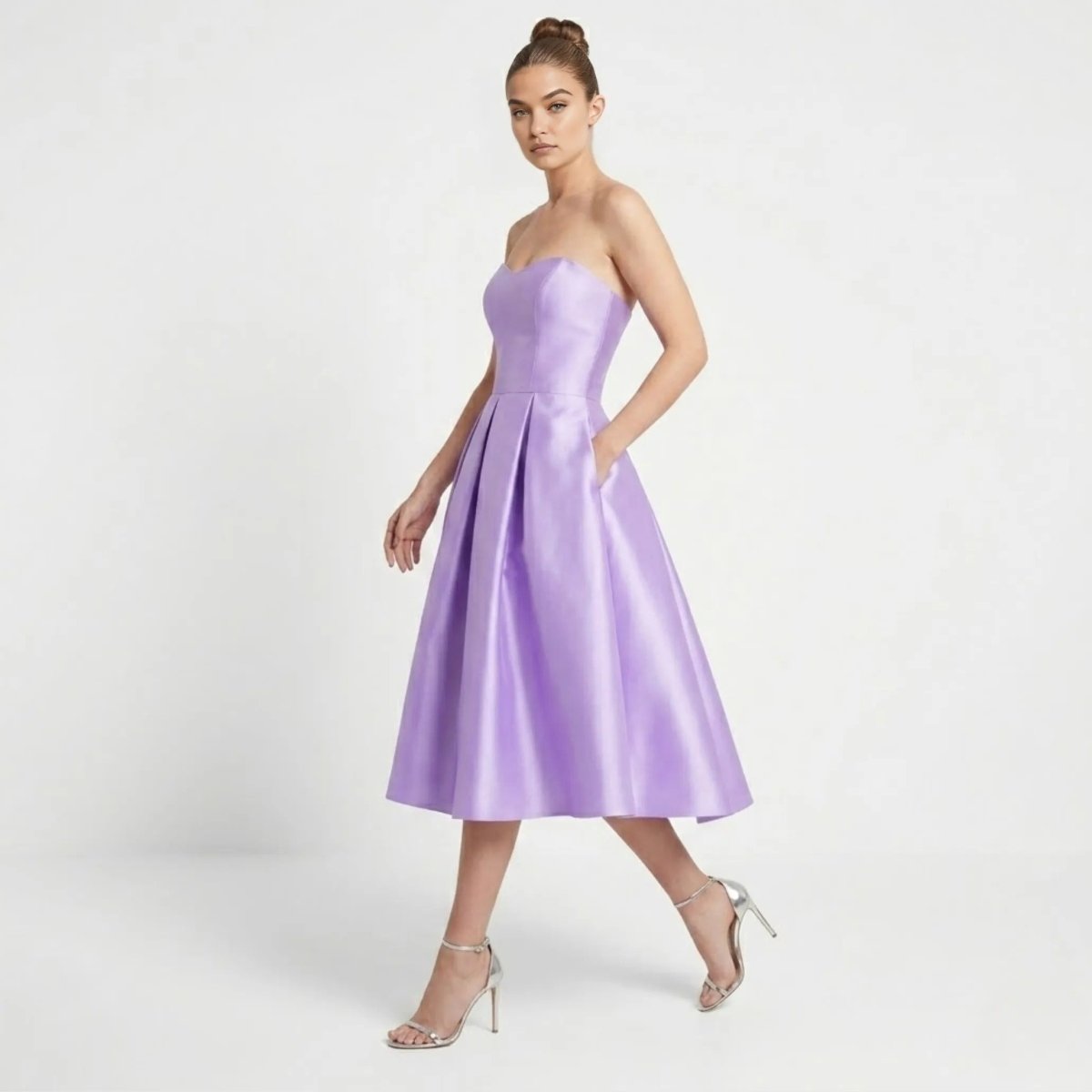 Side angle of the Kouvr purple satin A-line midi dress showcasing functional side pockets and a structured sweetheart neckline.