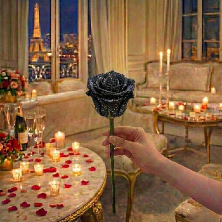 A hand holding an elegant single black glitter rose against a romantic background. A unique and striking eternal flower gift.