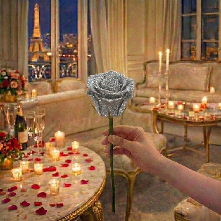 A hand holding a single metallic silver sparkle rose. A modern, chrome-look artificial flower stem.