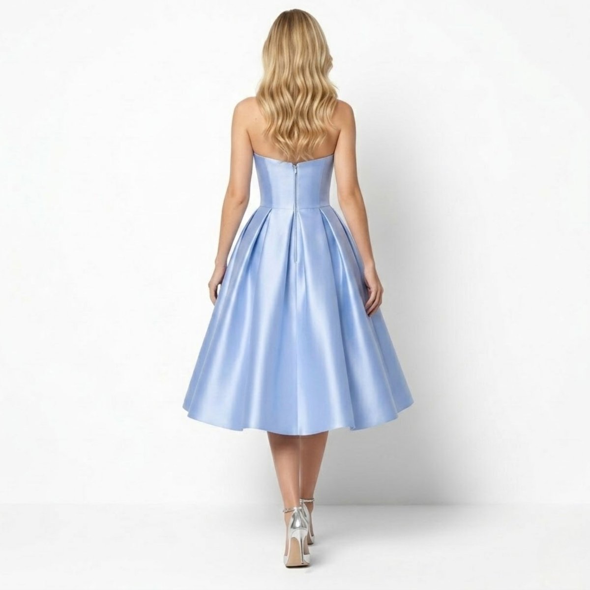 Back view of the sky blue strapless event gown featuring invisible zipper and elegant pleated back skirt details