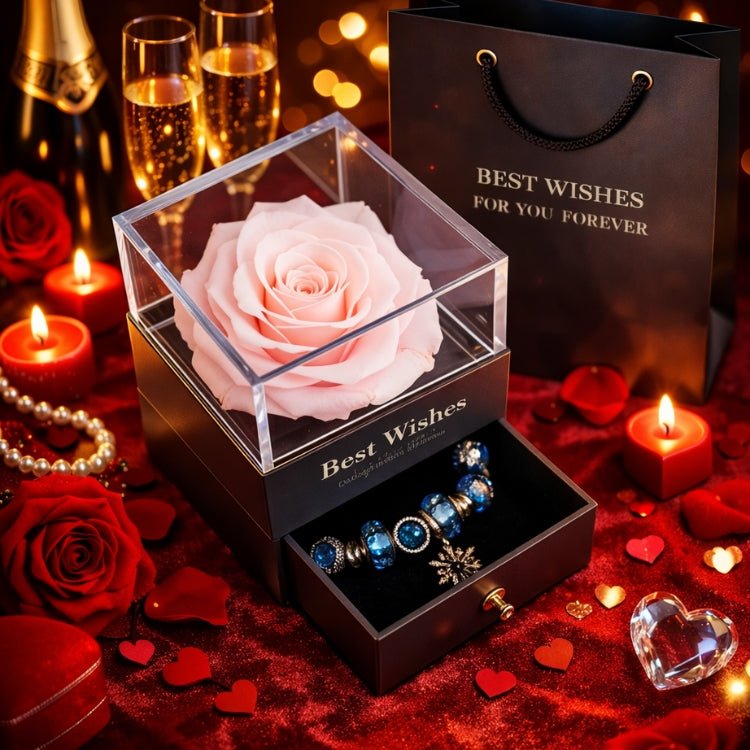 Elegant soft blush pink eternal rose in a square glass box with a blue beaded bracelet.
